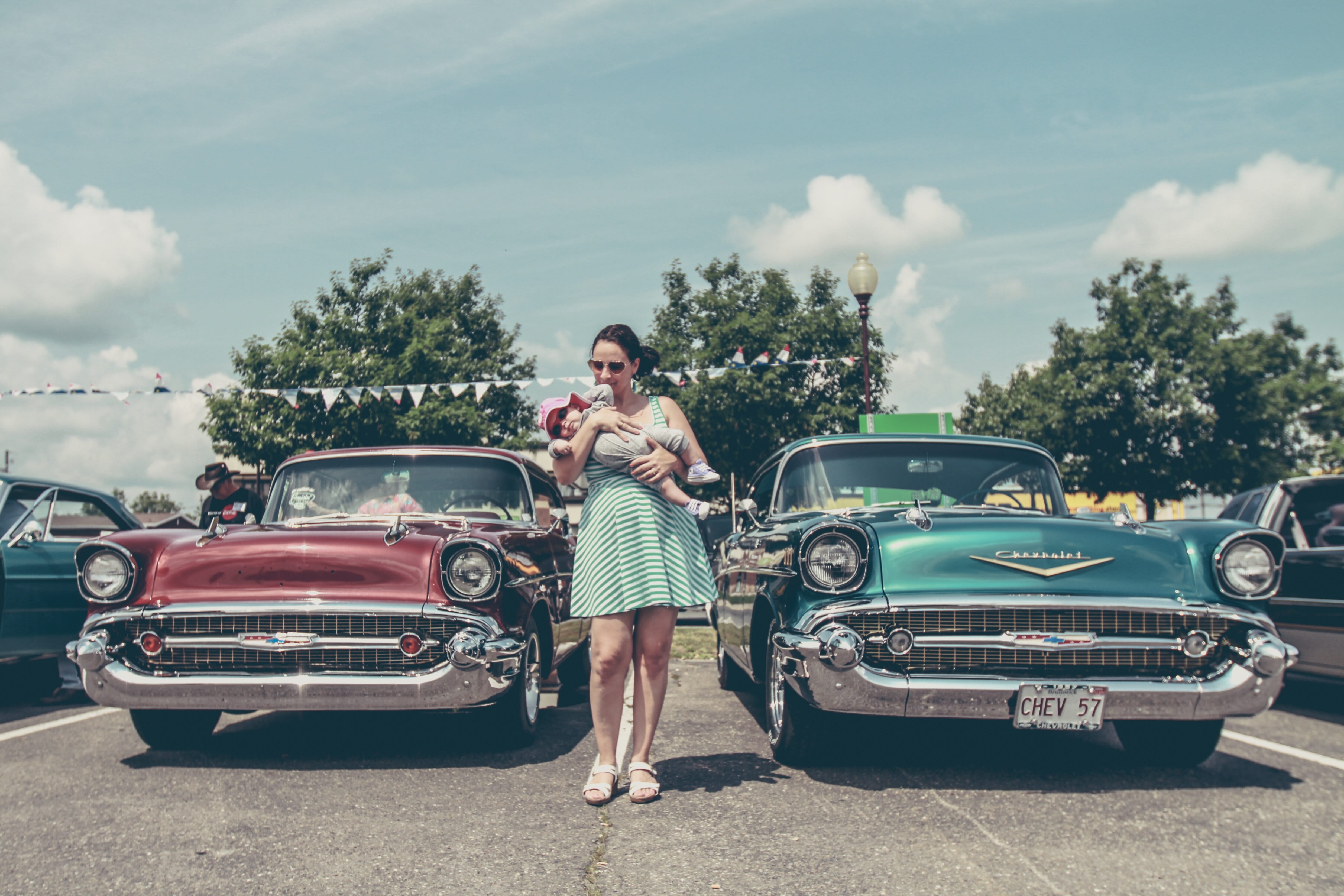 Lady and her son walking through a car show.