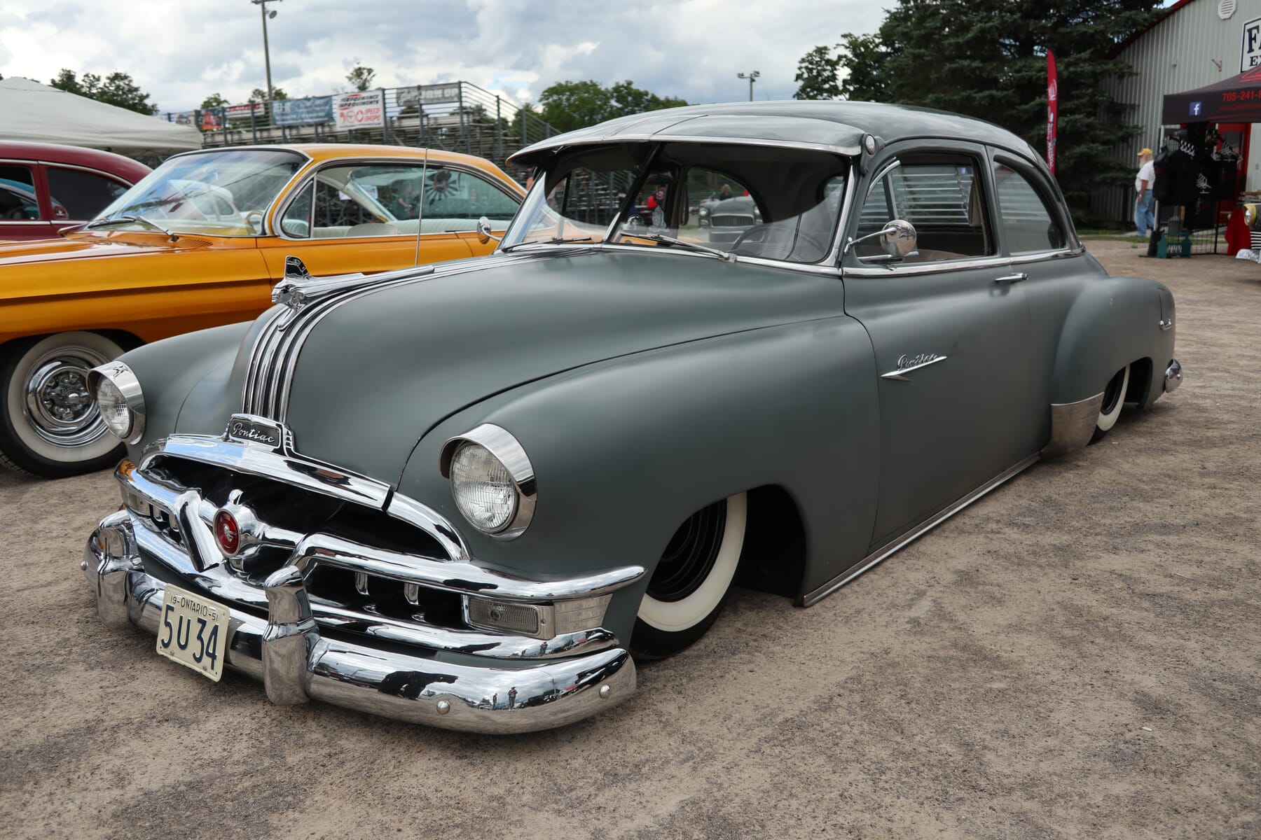 1951 Pontiac with flat grey paint and air suspension sitting on whitewall tires