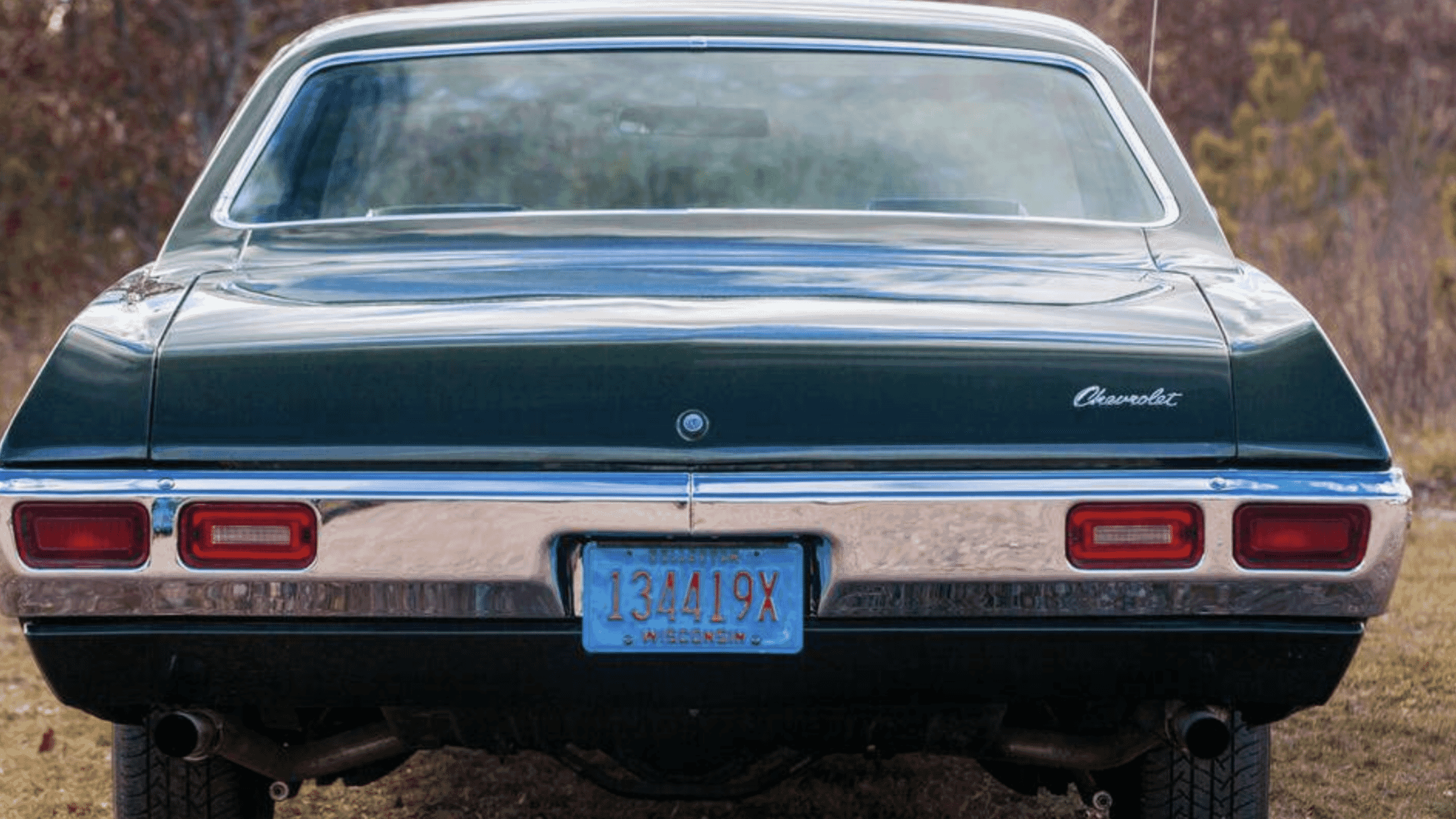 Rear view of a green 1969 Chevrolet Biscayne two door hardtop with a Wisconsin license plate
